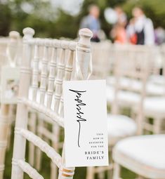 a white chair with a sign that says thank you for the bride's family