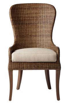 a wicker chair with a cushion on the back and armrests is shown in front of a white background