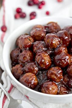 a white bowl filled with meatballs on top of a table