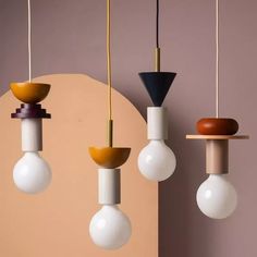 three different colored lights hanging from the ceiling