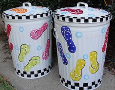 two trash cans painted with flip flops on them