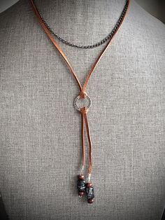 Leather cord necklace with steel chain and beaded accents, featuring a stainless steel ring engraved with the word "STRENGTH". Beaded Leather Necklace, Necklace Leather Cord, Leather Beaded Necklace, Leather Cord Necklace, Necklace Leather, Inspirational Jewelry, Leather Corded Necklace, Y Necklace, Necklace Beaded