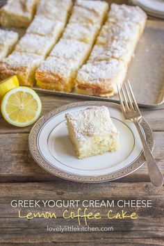 a plate with lemon cake on it next to some sliced lemons