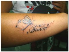 a woman with a dragon tattoo on her arm and the word simon written in cursive writing