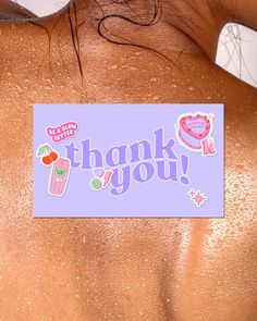 the back of a woman's body with thank you stickers on it