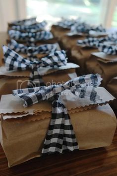 some brown paper bags with black and white bows on them