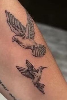 a couple of birds that are on the arm