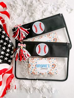 two personalized leather wallets with red, white and blue tassels on them next to an american flag