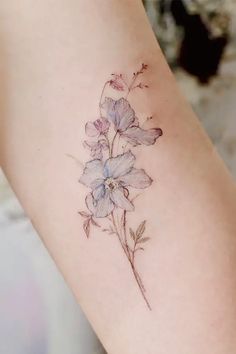 a flower tattoo on the arm