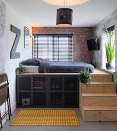 a bed sitting on top of a wooden floor next to a window