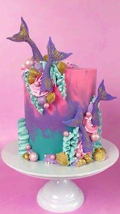 there is a cake with mermaid decorations on it