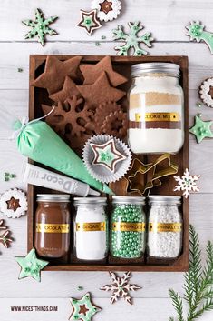 an assortment of christmas cookies and decorations in a wooden box