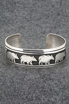 This sterling silver bracelet featuring a row of bears was made by Navajo silversmith Rosita Singer. The back is signed T&R Singer and stamped sterling.Size: 5 1/2" (will fit a 6 1/2" wrist)Gap: 1"Length: 3/4"Free shipping on all orders! We ship with USPS and always include tracking. All orders ship within a day of payment.Returns are accepted up to 30 days after you receive your order. Just send us a message. Our shop offers cash back or store credit. The item must be returned in new condition. Navajo Bracelet, Sterling Silver Bracelet, Native American Jewelry, Free Jewelry, Sterling Silver Bracelets, Bears, Silver Bracelet, Jewelry Watches, Jewelry Bracelets