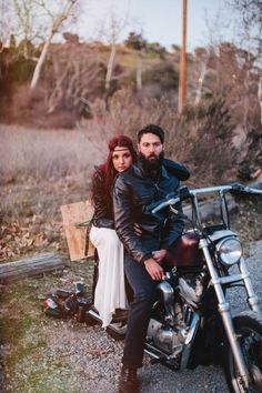 a man and woman are sitting on a motorcycle