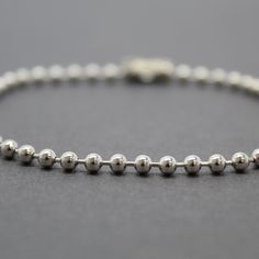 A simple yet beautiful everyday chain or bracelet. This is a bead or ball chain as some call it features 3mm beads. This is solid 925 sterling silver, not plated. You can select the shiny silver or opt to have it antiqued with the oxidized brushed patina. I measure the length in inches from end to end including the clasp. Made to Order Lengths~ Need a special length just ask! 925 Sterling Silver Bright and Shiny or Oxidized Antiqued Patina Fastens with a simple connector link The chain will arri Minimalist Beaded Chain Bracelet With Round Beads, Dainty Beaded Bracelets With Ball Chain, Minimalist Satellite Chain Bracelet With Round Beads, Minimalist Adjustable Chain Bracelet With Round Beads, Minimalist Chain Bracelet With Round Beads And Adjustable Chain, Everyday Ball Chain Bracelet, Everyday Beaded Ball Chain Bracelet, Minimalist Hypoallergenic Chain Bracelet With Round Beads, Minimalist Jewelry With Round Beads Chain