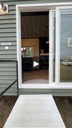 an open door to a house with a ramp leading up to the front door and outside