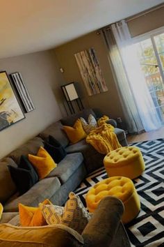 a living room filled with lots of furniture and decor on top of a black and white rug