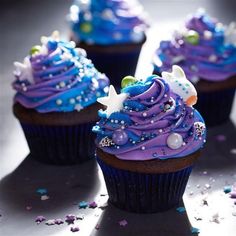 three cupcakes with purple frosting and stars on them