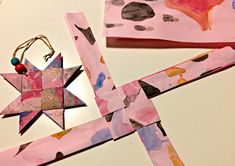 paper and crafting materials are laid out on the table to make an origami star