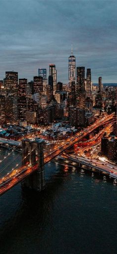 an aerial view of the city lights and bridges at night, as seen from above