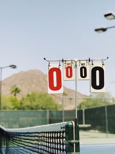 there are two signs that say no to the tennis court, and one is hanging on a chain link fence