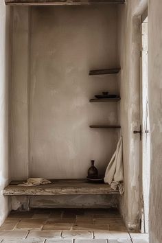 an empty room with shelves and a vase