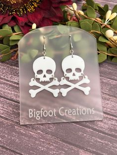 Channel your inner pirate or add a touch of gothic flair with these bold skull and crossbones earrings! Crafted from high-quality acrylic, these earrings feature a striking skull and crossbones design that's perfect for making a statement. Whether you're celebrating Halloween or simply love edgy accessories, these earrings will add a daring touch to any outfit. Lightweight and comfortable to wear, these earrings are an ideal choice for anyone who enjoys unique and standout jewelry. They also mak Gothic White Dangle Jewelry, White Gothic Dangle Jewelry, White Gothic Skull Jewelry, Gothic Skull Earrings For Halloween, White Gothic Handmade Earrings, Handmade White Gothic Earrings, White Skull-shaped Halloween Jewelry, Halloween Skull Jewelry In White, Halloween White Skull Jewelry