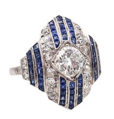 An art deco platinum ring with sapphires Beautiful antique cocktail ring, created in America during the art deco period, back in the 1930. This beautiful ring was crafted in solid platinum and mount with a great selection of natural gemstones. The ring is designed with geometric shapes and the gem's settings are finished with millegrain patterns. Diamond: Mount in the center in a flush four-prongs setting, with 1 European round cut diamond of 1.18 carats, white colorless F color, SI clarity. Dia Antique Cocktail Ring, American Art Deco, Blue Sapphire Diamond Ring, French Baguette, Antique Jewelry Rings, Blue Sapphire Diamond, Geometric Ring, Jewelry Techniques, Art Deco Period