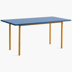 a blue table sitting on top of a white floor next to a yellow frame and wooden legs