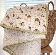 a pillow with deers on it sitting next to a chair and window sill