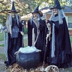 three people dressed up in halloween costumes standing next to a caulder filled with cotton