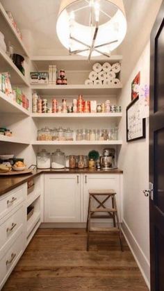 a kitchen with white cabinets and stars painted on the wall above it is an open pantry