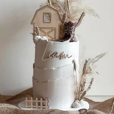 there is a cake that has been made to look like a barn and some wheat