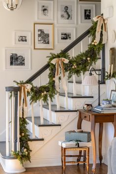 a staircase decorated for christmas with garland and lights