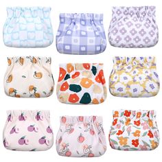 six different types of cloth diapers with flowers and fruits on them, all in various colors