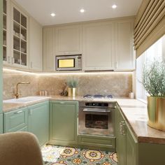 a kitchen with green cabinets and white walls