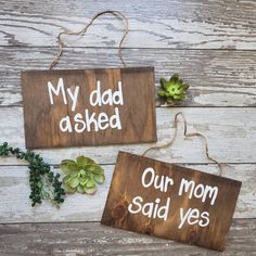 two wooden signs that say, my dad asked our mom said yes