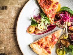 three slices of pizza on a white plate