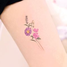 a woman's thigh with flowers tattooed on the back of her leg and arm