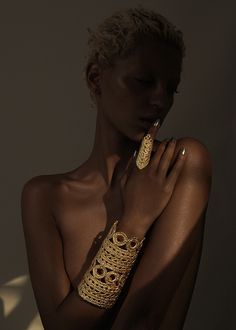 a woman with gold bracelets on her arm