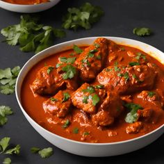 two bowls filled with meatballs and garnished with cilantro