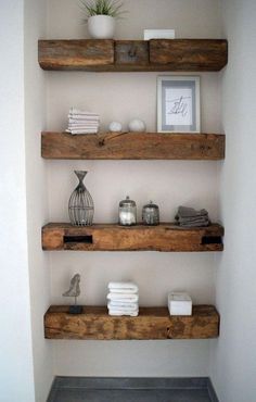 some shelves in a bathroom with towels and candles