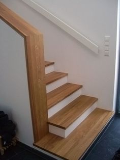 the stairs are made of wood and have white painted treads on each one side