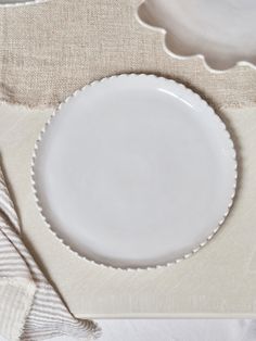 a white plate sitting on top of a table next to a fork and spoons