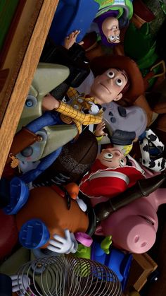 the toy story characters are piled up together