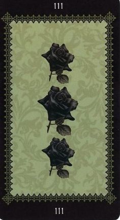 a card with three roses on the front and four petals on the back, all in black