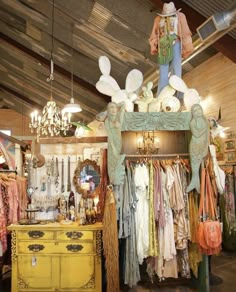 an old fashion store with lots of clothes on display and decorations hanging from the ceiling