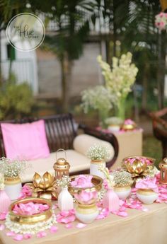 a table with pink and gold decorations on it