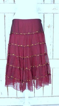 "Vintage sheer silk dark red ruffle midi skirt/mid length tiered festival skirt/90s burgundy/maroon silk skirt/large Features... -sheer 100% overlay -accented with metallic gold threading -stretch poly lining -midi length -zipper side -90's vintage Measurements...taken flat -marked size: large -across waist: 18\" -length: 29\" Condition... -excellent vintage condition -minimal wear UJ2065" Flowy Ruffle Midi Dress, Flowy Ruffled Maxi Full Skirt, Fitted Bohemian Skirt With Ruffles, Elegant Fitted Maxi Skirt For Festival, Fall Tiered Ruffled Skirt, Flowy Fall Maxi Skirt With Ruffles, Fitted Tiered Maxi Skirt For Festival, Elegant Long Skirt For Festivals, Elegant Festive Ruffle Skirt