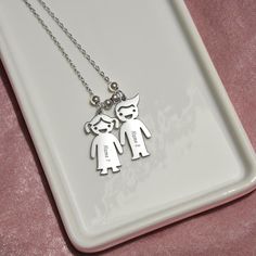 Mom, Children leave footprints on a mother's heart, forever changing her life's path. This unforgettable gift will leave your mother speechless! Introducing the Engraved Kids Charm Necklace. This necklace features up to three engraved charms, each shaped like a child, and can be personalized with the name or word of your choice. Made with high-quality materials, this necklace is a perfect gift for mothers and grandmothers who want to keep their children or grandchildren close to their heart. Whe Sterling Silver Necklaces For Mother's Day, Engraved Necklace For Valentine's Day, Silver Necklaces For Mother's Day, Silver Necklace For Mother's Day, Mothers Heart, Personalized Grandma, Gift For Grandma, Charm Pendant Necklace, Luxury Boxes